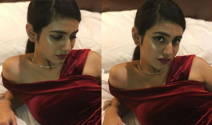 Malayalam Hottie Priya Prakash Varrier Poses Seductively In Bedroom Wearing Sexy Maroon Gown