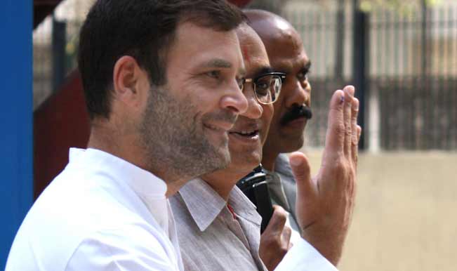 Congress-vice-president-Rahul-Gandhi-shows-his-fore-finger-marked-with-phosphoric-ink-after-casting