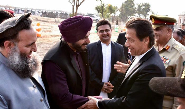 Pakistan Prime Minister Imran Khan shakes hands with cricketer-turned-Indian politician Navjot Singh Sidhu during ground breaking ceremony for Kartarpur corridor