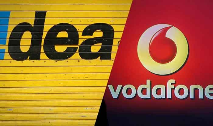A man communicates on a phone next to the Vodafone Idea logo on the shutter  of