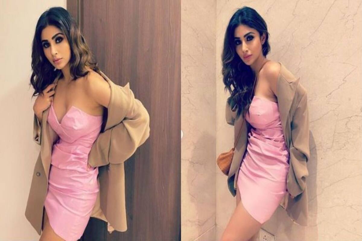 Mouni Roy lounges on the sea rocks in baby pink bralette top