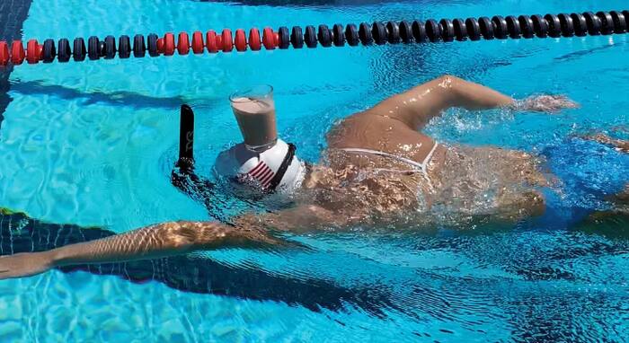 Olympian Katie Ledecky Swims Across Pool With Glass Of Milk Balanced On 