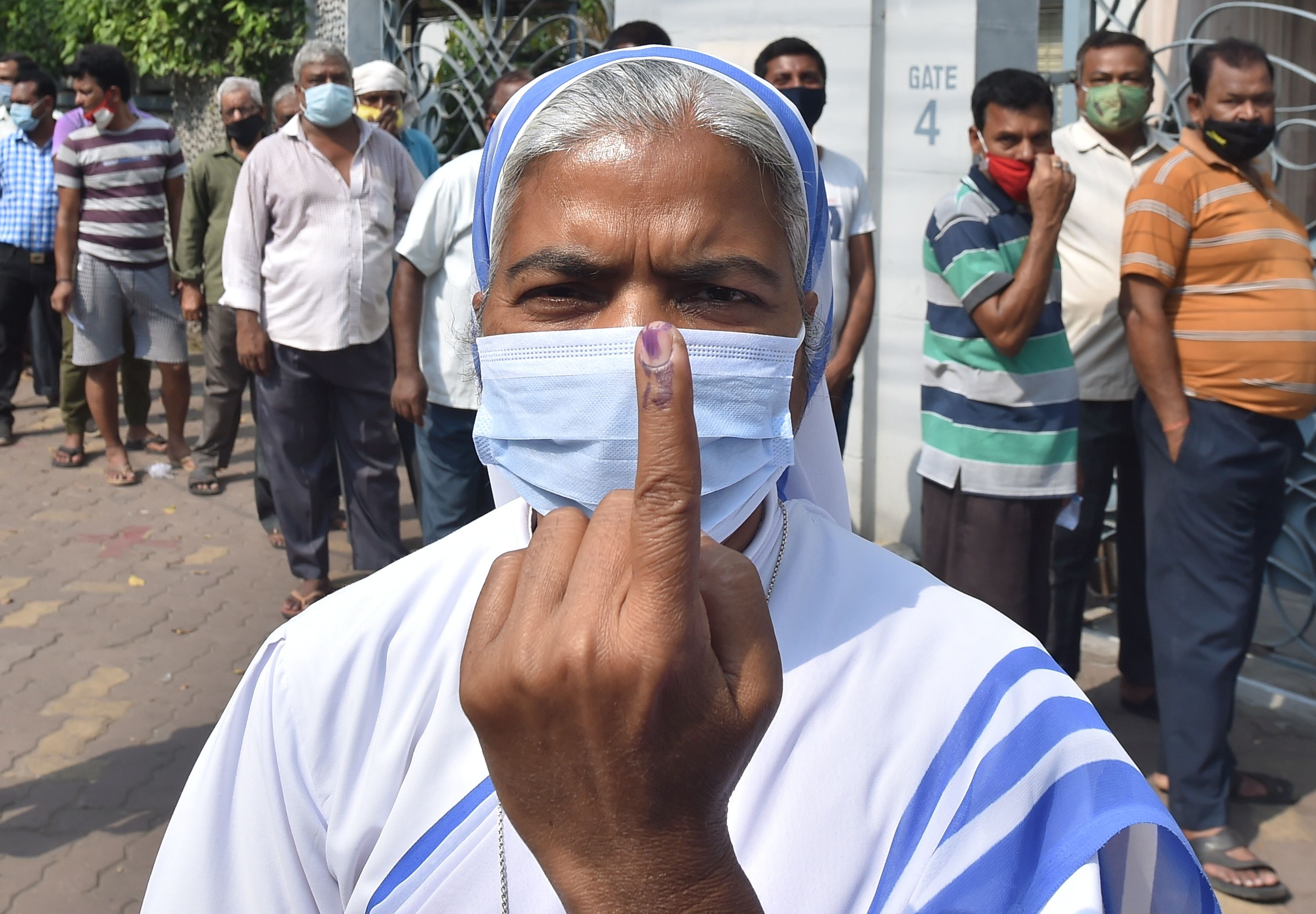 A nun of Missionaries of charity shows her finger marked with indelible ink after casting vote during the 7th phase of State Assembly poll at a polling station in Kolkata, Monday, April 26, 2021. (PTI Photo)