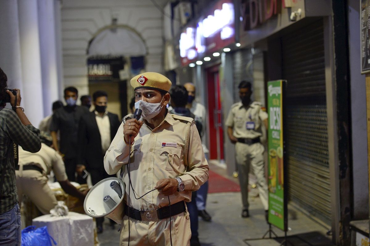 Security personnel during night curfew, imposed by Delhi government to curb COVID-19 spread, at Connaught Place in New Delhi, Tuesday, April 6, 2021. (PTI Photo)
