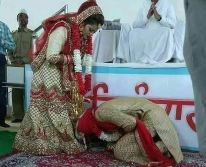 Photo of a Groom Touching his Bride’s Feet Goes Viral and the Reason Will Take You By Surprise
