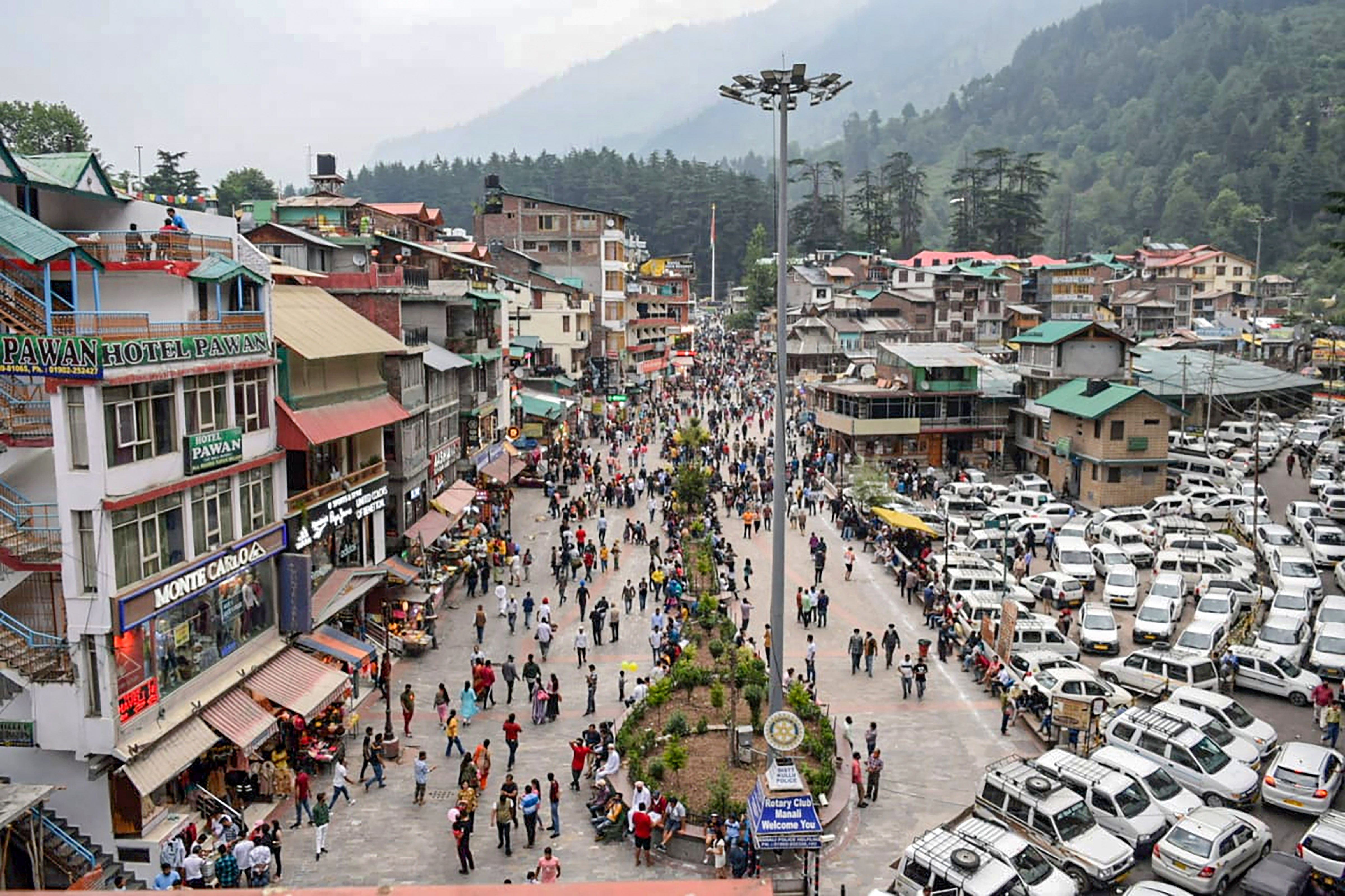 Tourists visit the Mall Road afoter relaxation in COVID-19 curfew, in Manali, Saturday, July 3, 2021. (PTI Photo)