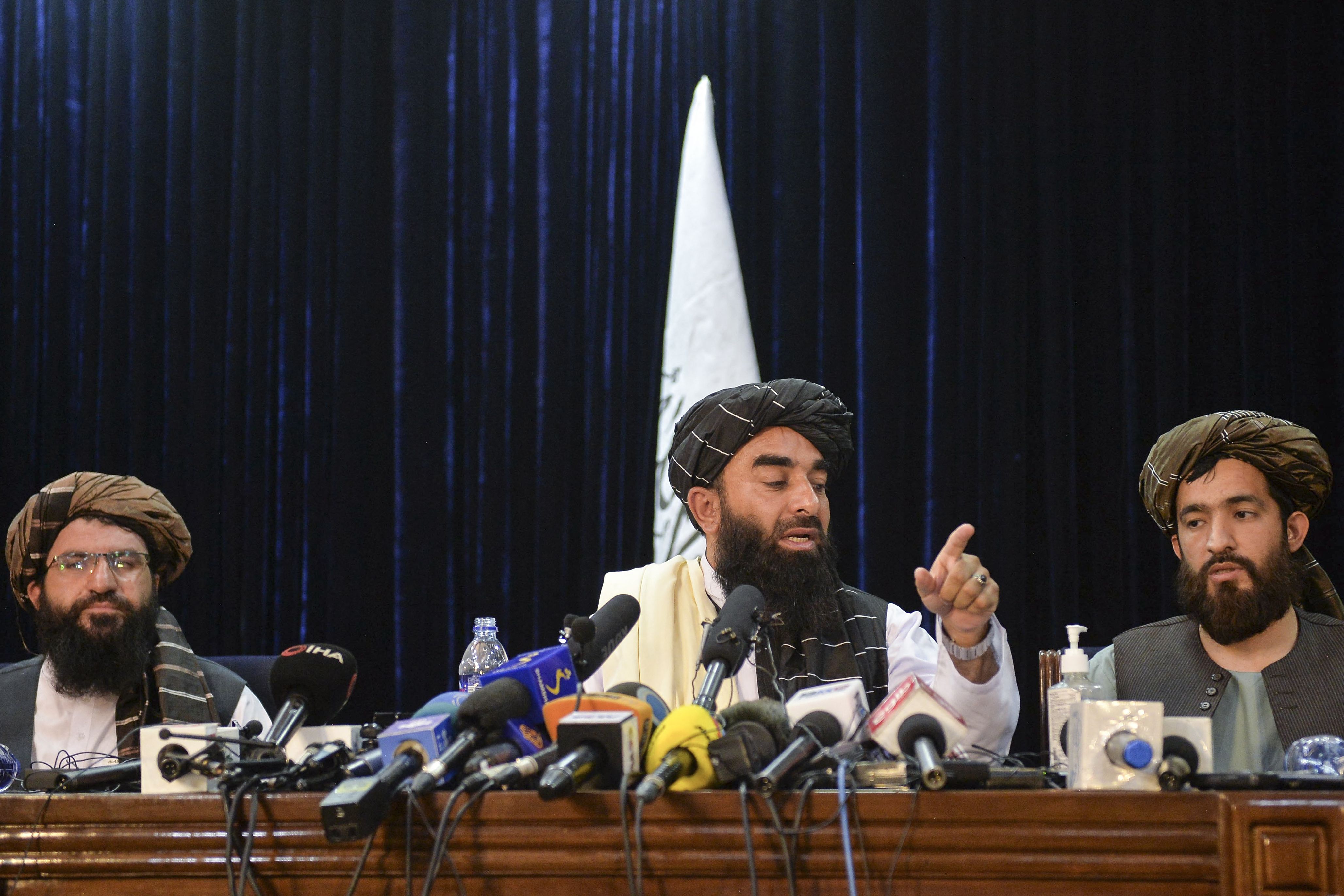 Taliban spokesperson Zabihullah Mujahid (C) gestures as he addresses the first press conference in Kabul on August 17, 2021 following the Taliban stunning takeover of Afghanistan. (AFP Photo)