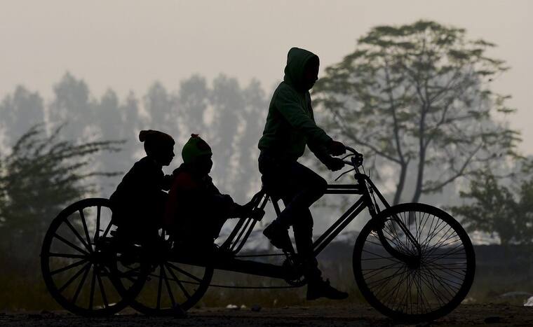 A man rides a tri-cycle during a cold winter morning, in New Delhi, Wednesday, Dec 29, 2021. (PTI Photo)
