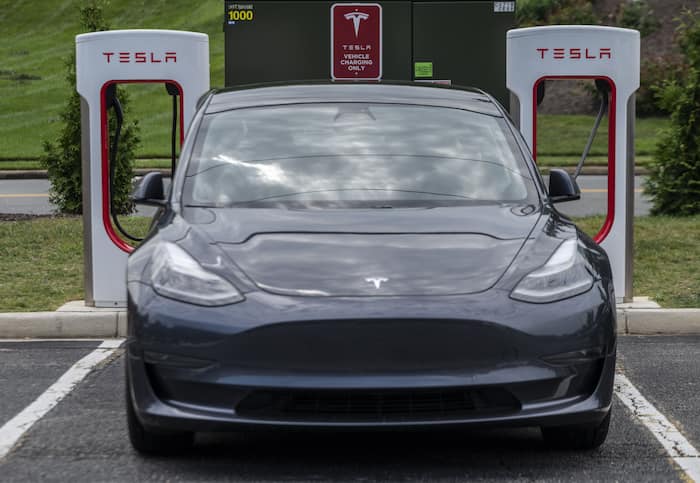 Cars charge at a Tesla super charging station in Arlington, Virginia on August 13, 2021