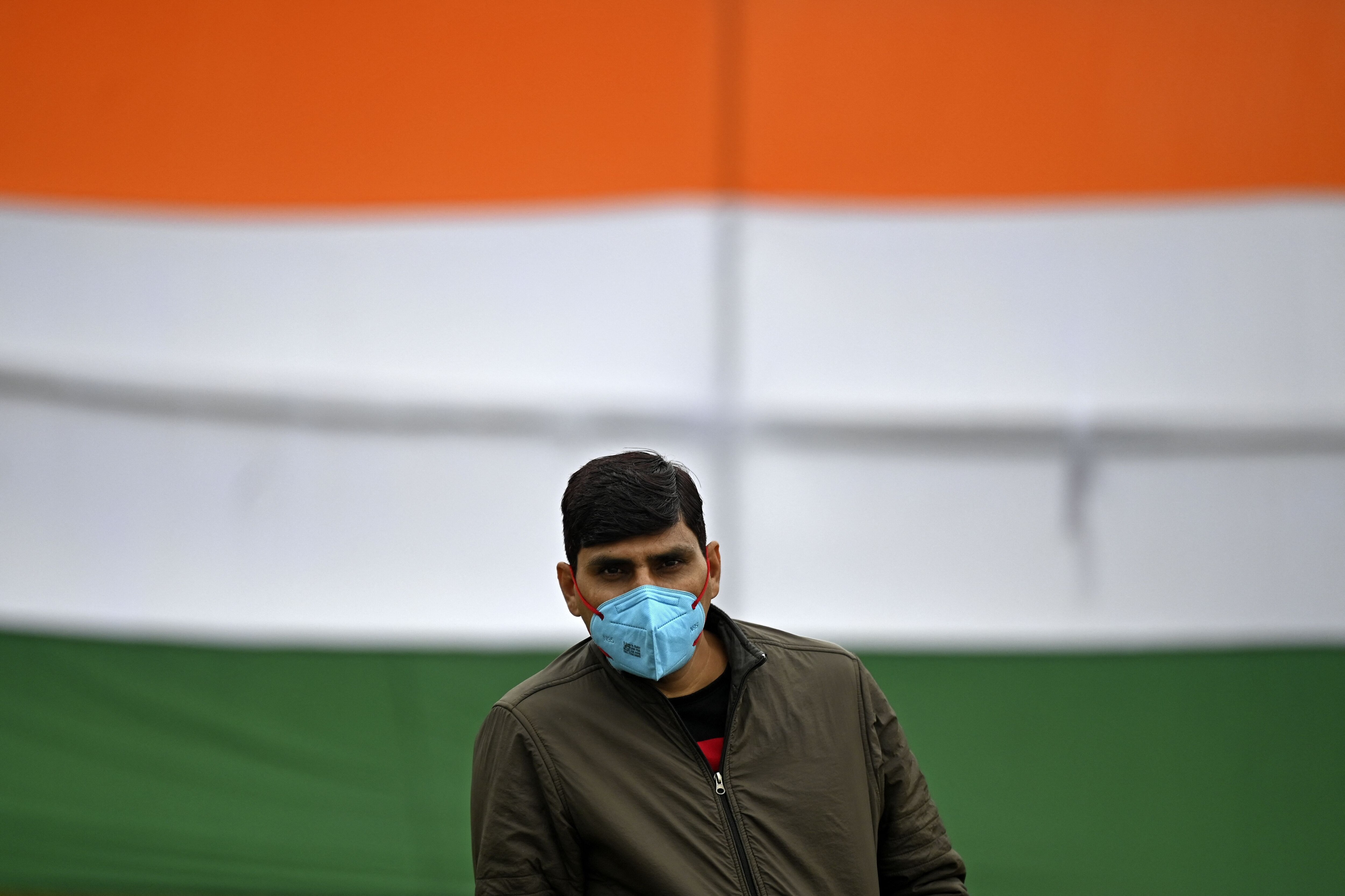 A man wearing a facemask as a preventive measure against the spread of the Covid-19 coronavirus stands along the Rajpath ahead of the Republic Day parade in New Delhi on January 24, 2022.(AFP photo)