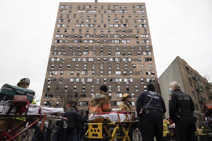Emergency personnel work at the scene of a fatal fire at an apartment building in the Bronx on Sunday, Jan. 9, 2022, in New York. (AP Photo/Yuki Iwamura)