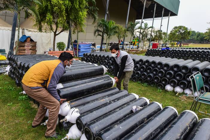 Workers place oxygen cylinders at a Covid care centre of the Commonwealth Games (CWG) village as part of the preparations for the third wave of COVID-19, in New Delhi, Thursday, Jan. 6, 2022. (PTI Photo