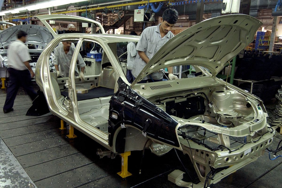 worker manufacturing car in India