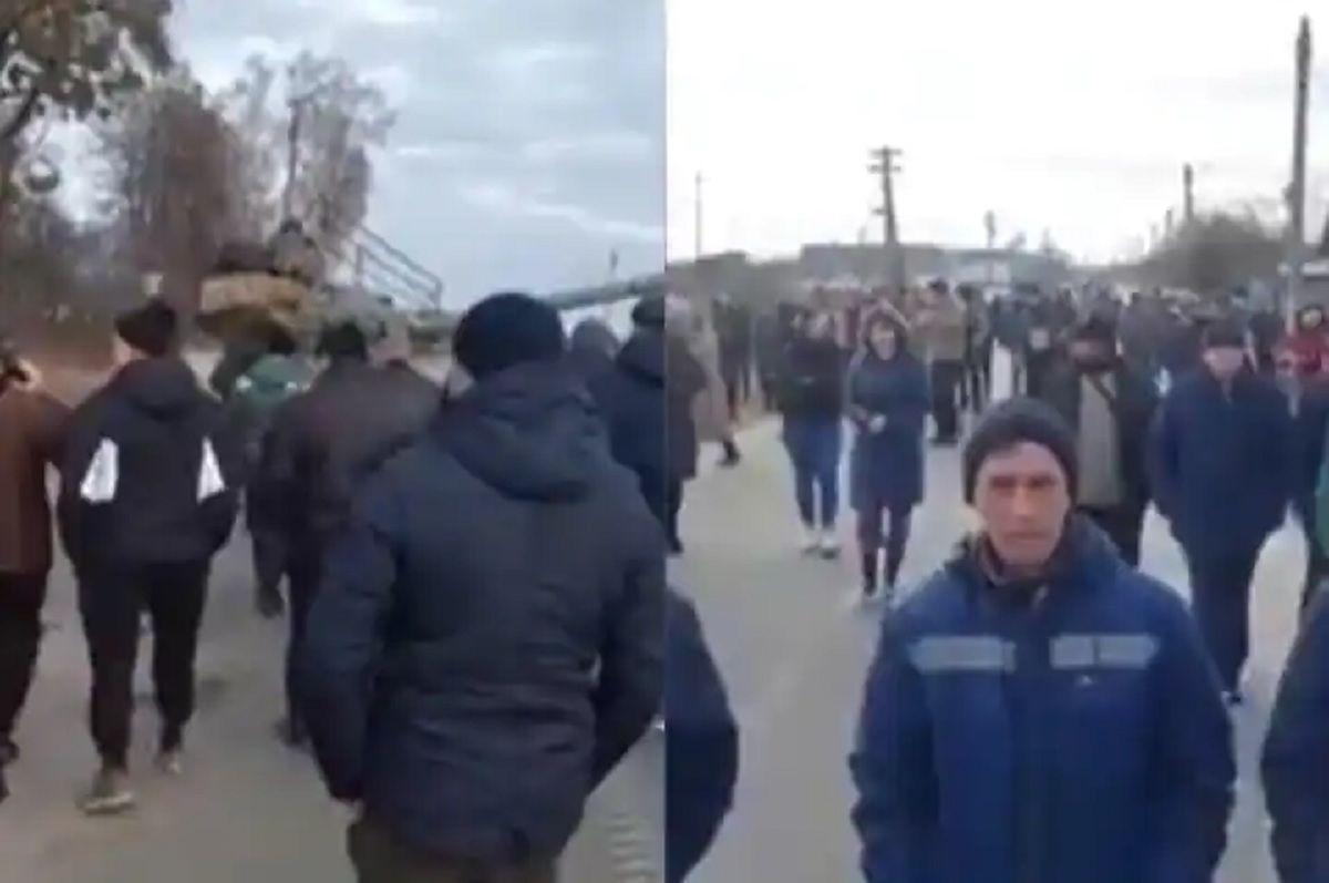 Hundreds of locals can be seen blocking the path of Russian tanks in northern Ukraine.