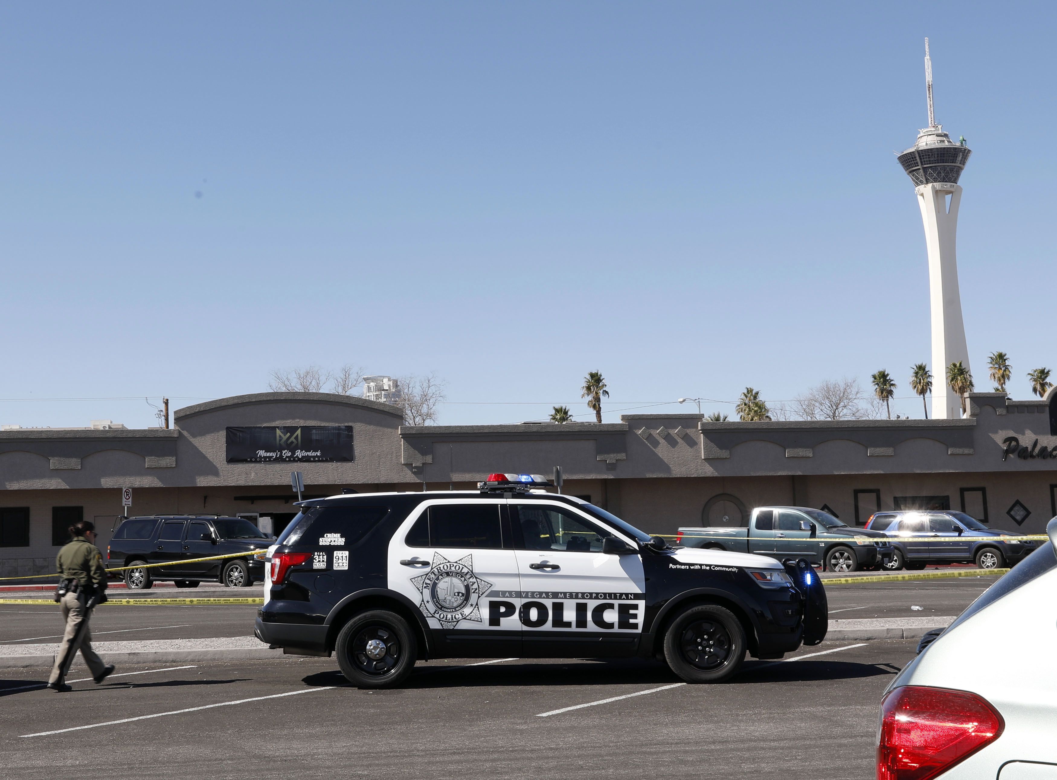 Las Vegas police investigate at Manny's Glow Ultra Lounge & Restaurant, after a shooting, Saturday, Feb. 26, 2022, in Las Vegas. Multiple people were shot before dawn Saturday morning at a hookah parlor. (Chitose Suzuki/Las Vegas Review-Journal via AP)