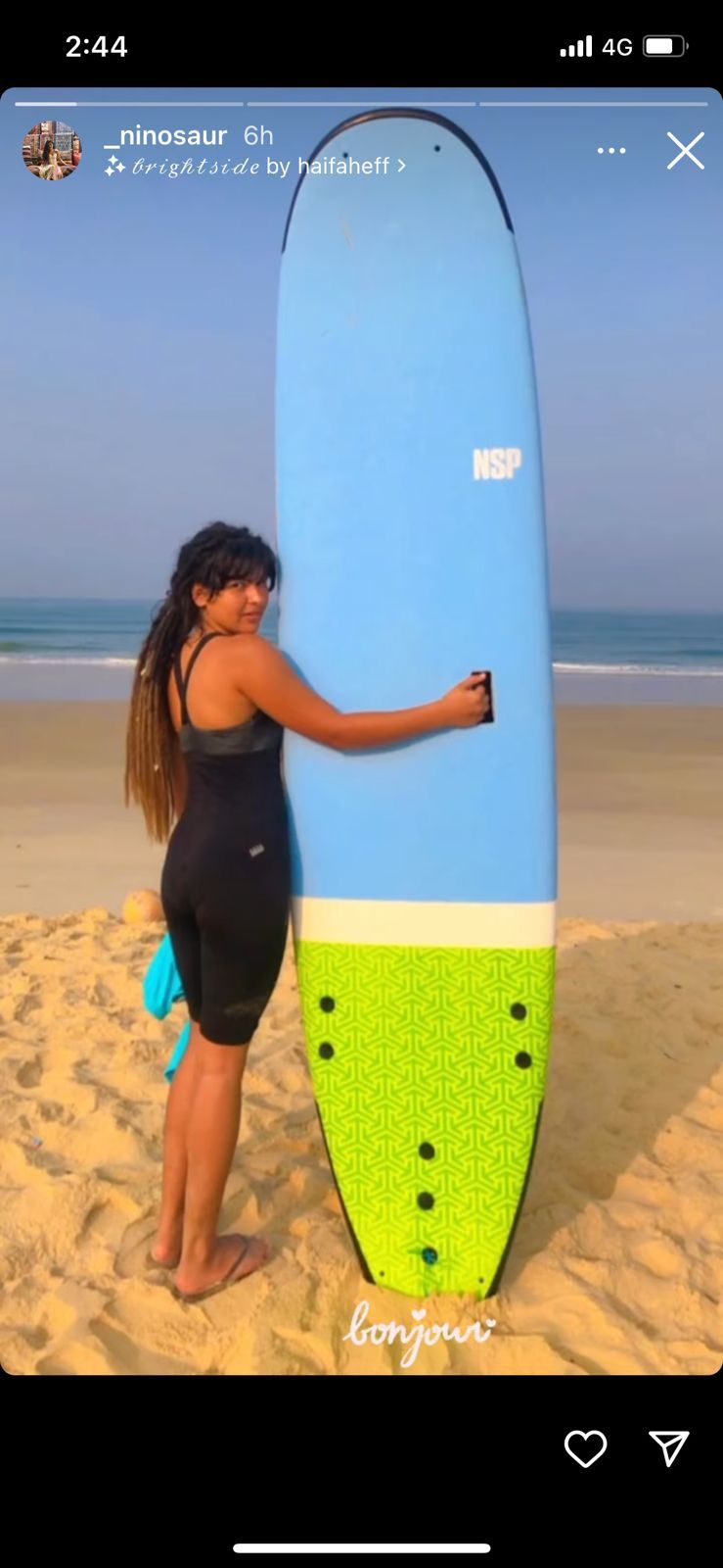 Nidhi Bhanushali posed with a surfing board