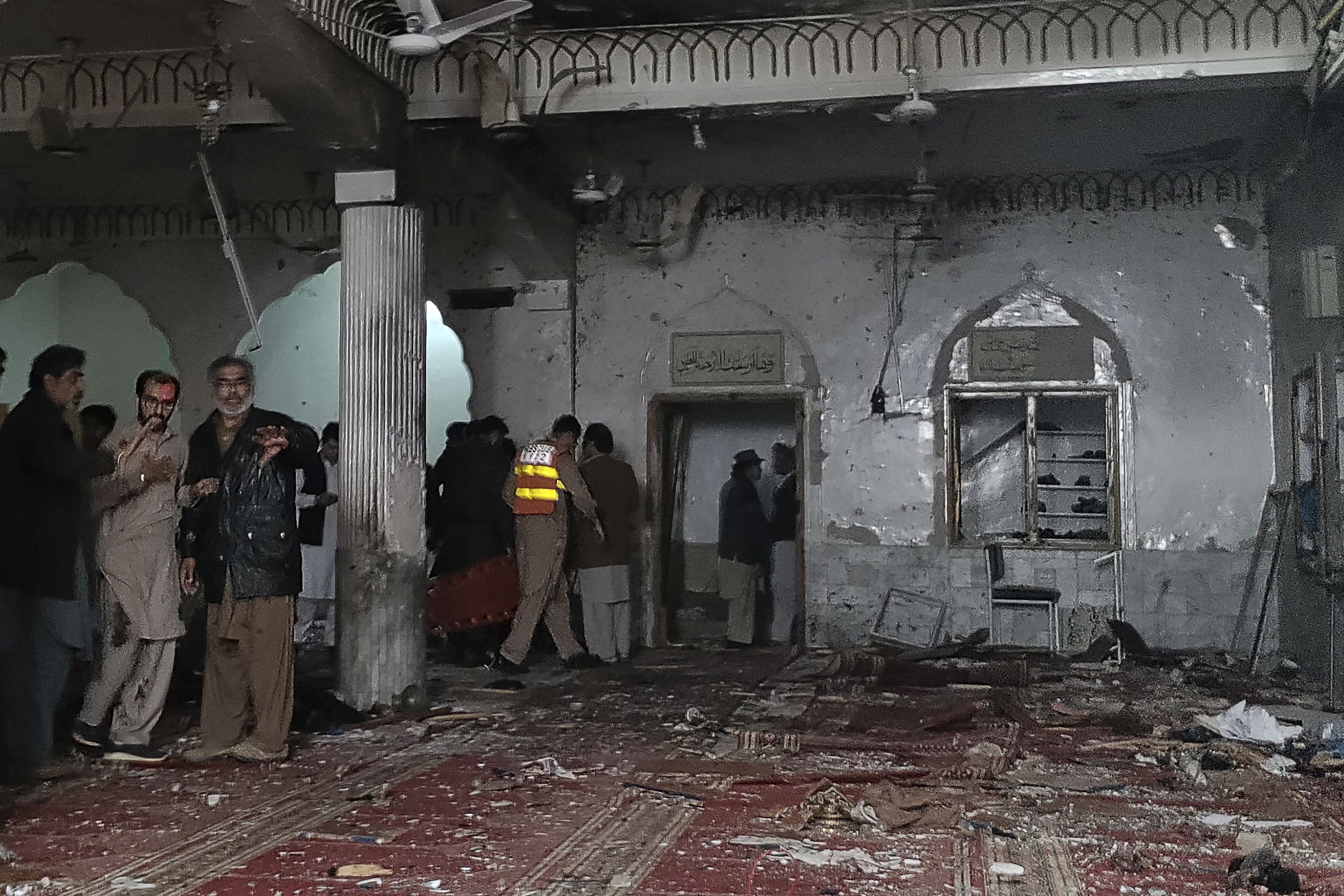 Security personnel inspect a mosque after a bomb blast in Peshawar on March 4, 2022. At least 30 people were killed and 56 wounded in a huge blast at a mosque in the northwestern Pakistani city of Peshawar, a hospital official said on March 4.