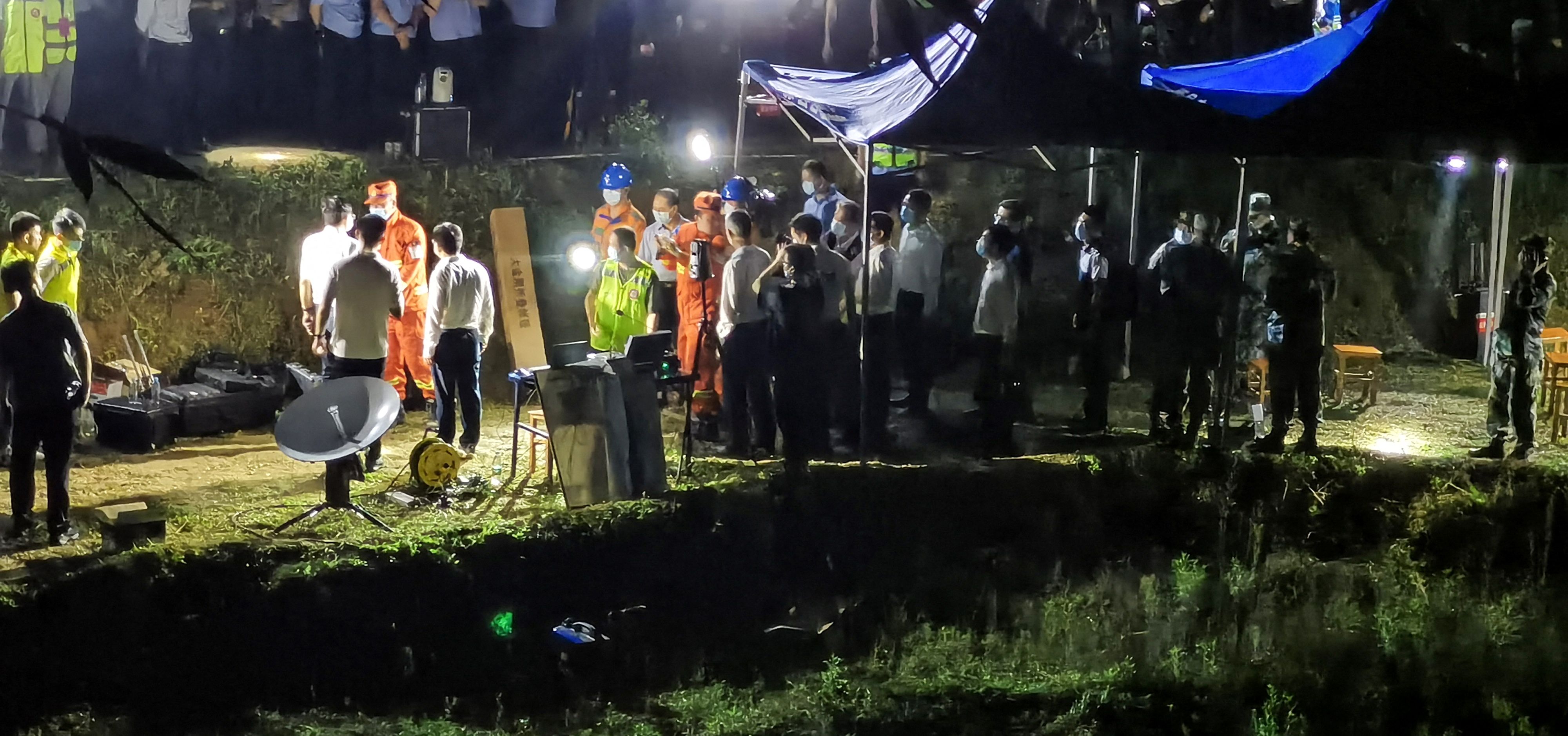 This photo taken on March 21, 2022 shows rescuers working at the site of a plane crash in Tengxian county, Wuzhou city, in China's southern Guangxi region. A China Eastern passenger jet carrying 132 people crashed onto a mountainside in southern China on March 21 causing a large fire, shortly after losing contact with air traffic control and dropping thousands of metres in just three minutes.