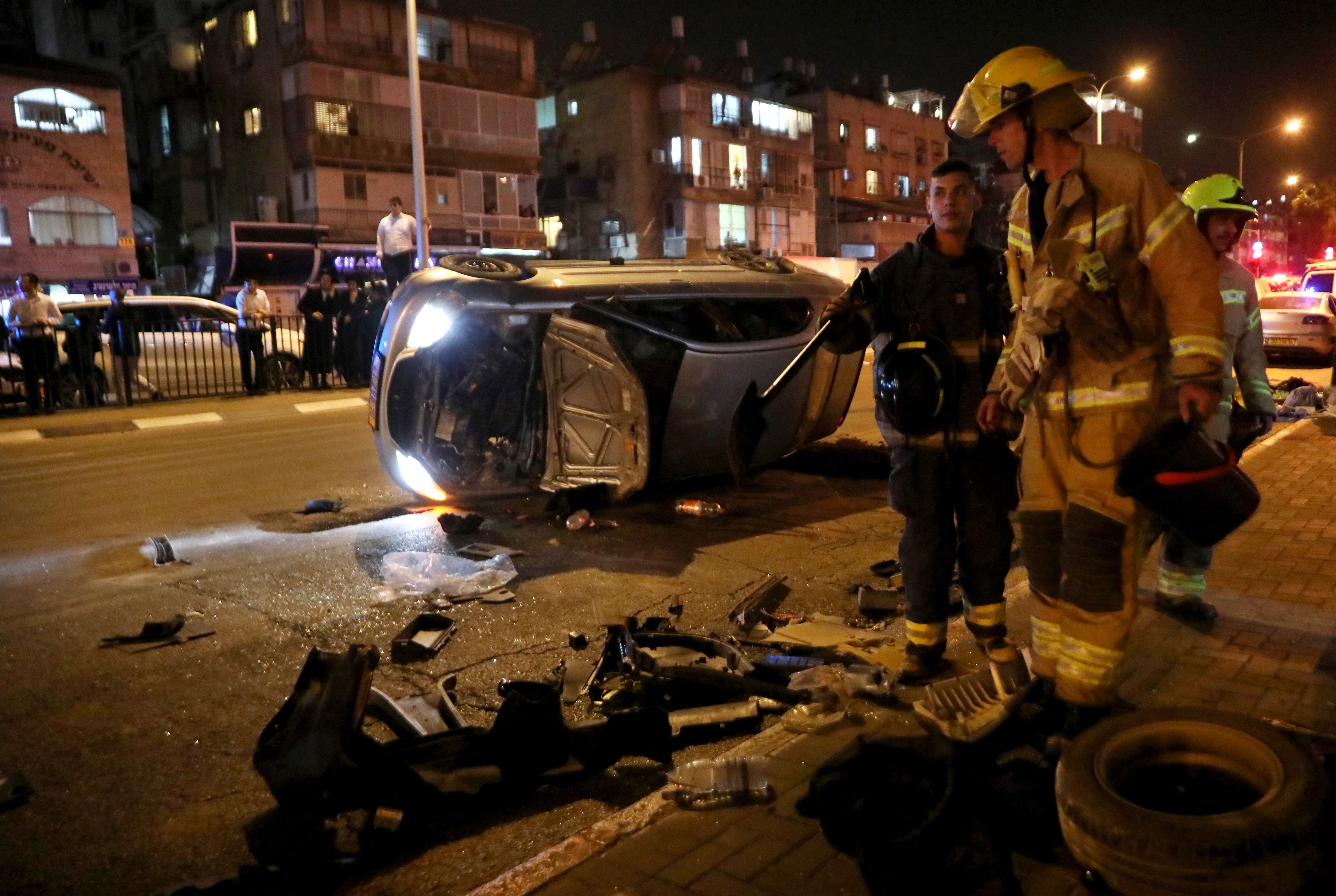 An overturned vehicle lies on the road at the scene of a shooting attack on March 29, 2022 in Bnei Brak, 7km (4.5 miles) east of Tel Aviv. Five people were killed in gun attacks Tuesday near the Israeli coastal city of Tel Aviv, emergency responders said, in the third fatal gun or knife spree in the Jewish state in a week (AFP photo)