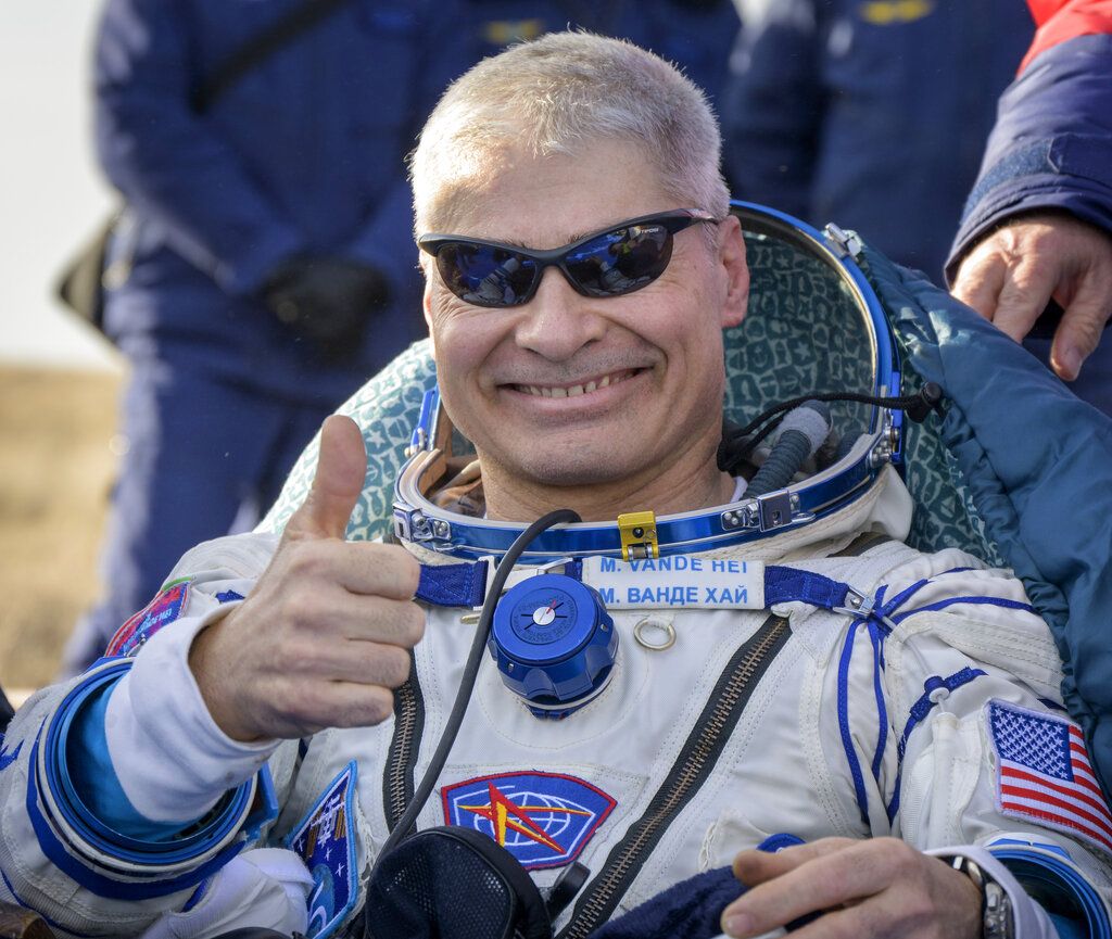 NASA astronaut Mark Vande Hei gives the thumbs up outside the Soyuz MS-19 spacecraft after he landed with Russian cosmonauts Anton Shkaplerov and Pyotr Dubrov in a remote area near the town of Zhezkazgan, Kazakhstan on Wednesday, March 30, 2022. (Bill Ingall/NASA via AP)