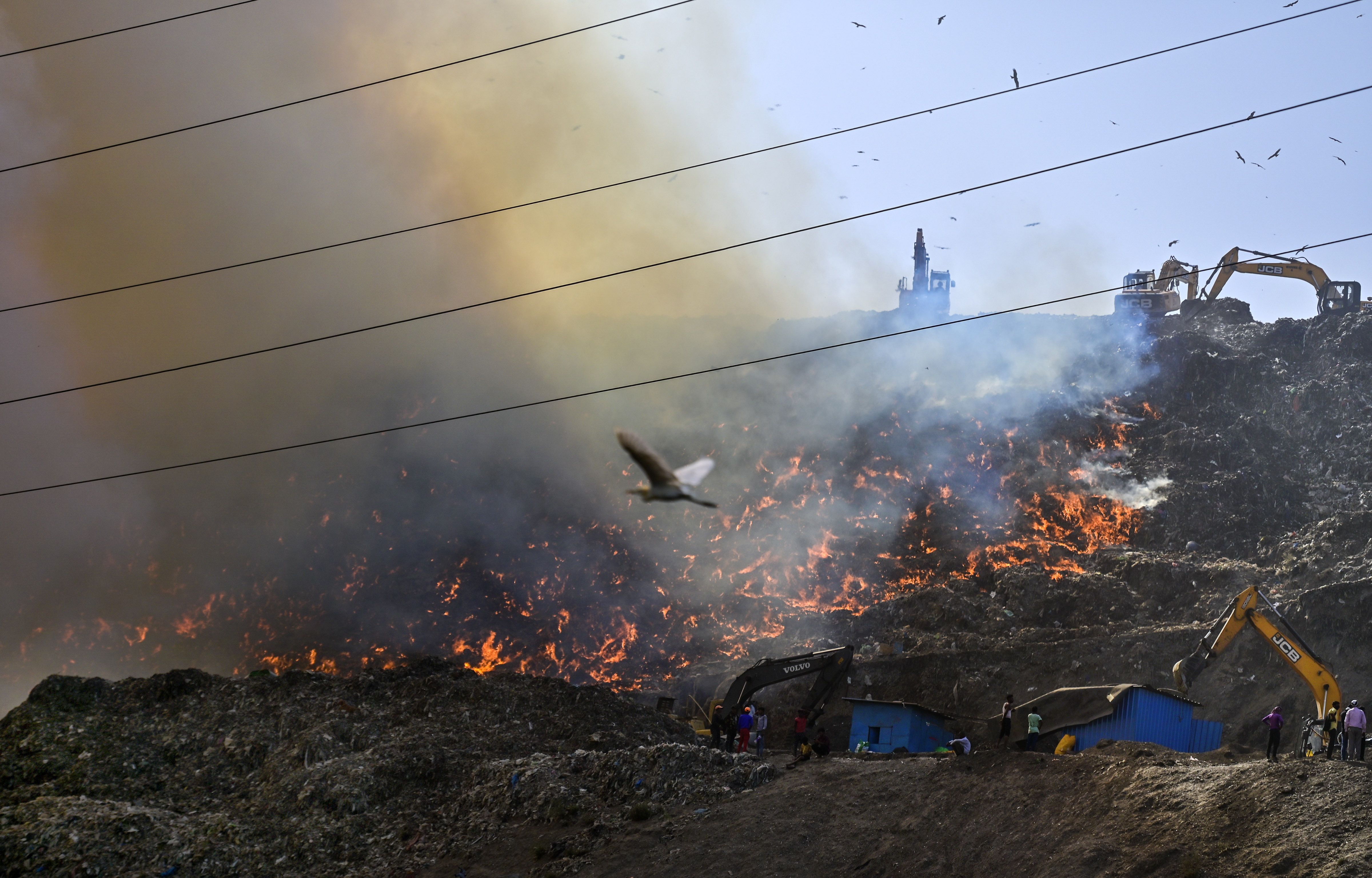 Flames and smoke rise from a fire at Ghazipur Landfill, in New Delhi, Monday, March 28, 2022. (PTI Photo)