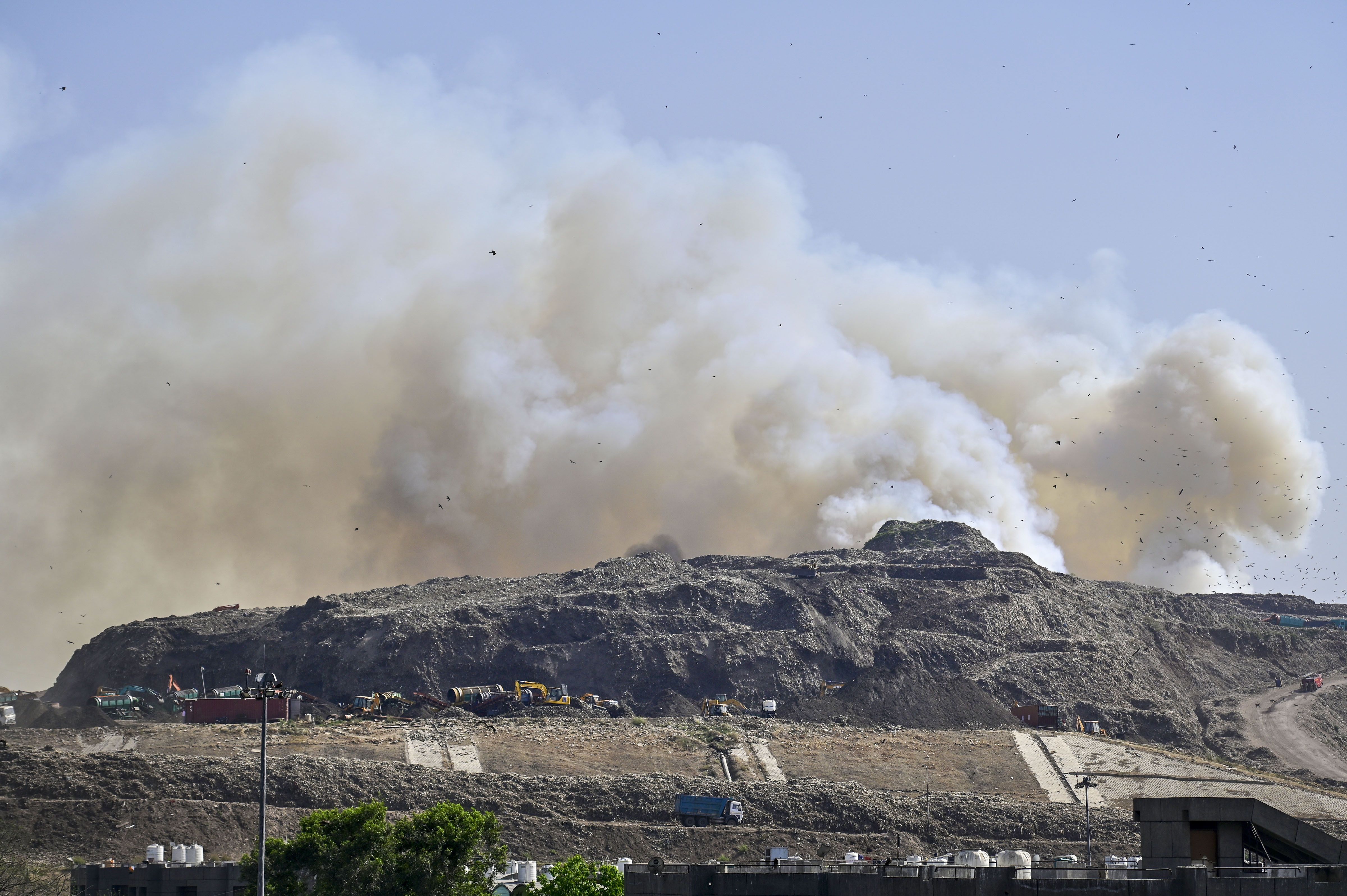 Flames and smoke rise from a fire at Ghazipur Landfill, in New Delhi, Monday, March 28, 2022. (PTI Photo)