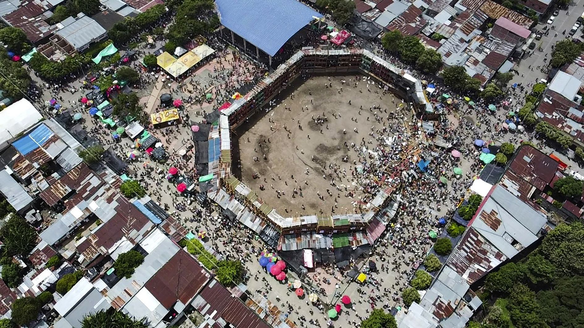 Aerial view of the collapsed grandstand in a bullring in the Colombian municipality of El Espinal, southwest of Bogotá, on June 26, 2022. At least four people were killed and another 30 seriously injured when a full three-story section of wooden stands filled with spectators collapsed, throwing dozens of people to the ground, during a popular event at which members of the public face off with small bulls, officials said.