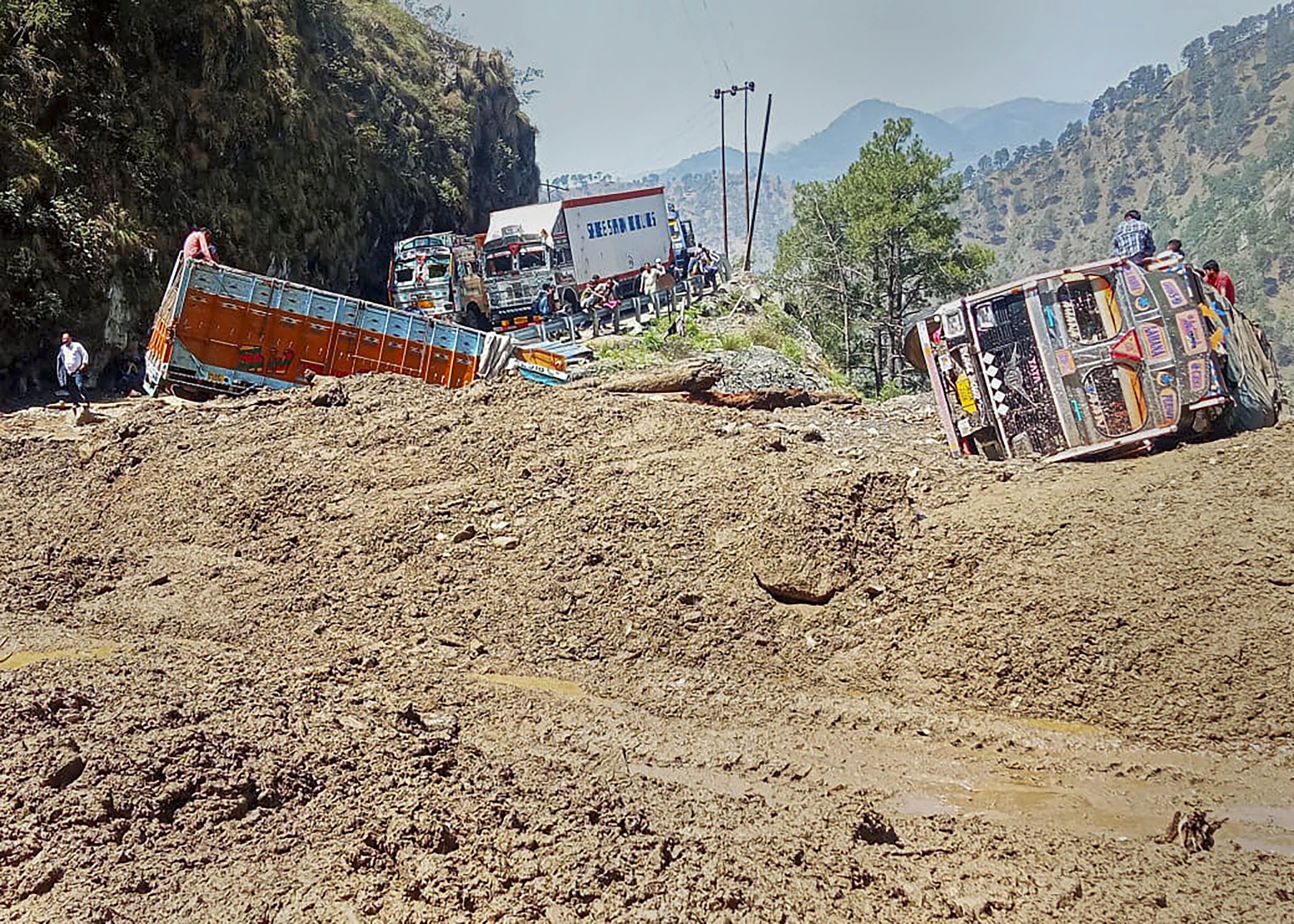 Trucks stranded as the Srinagar-Jammu National Highway was blocked after landslide due to rains, in Banihal sector, Thursday, June 23, 2022. (PTI Photo)