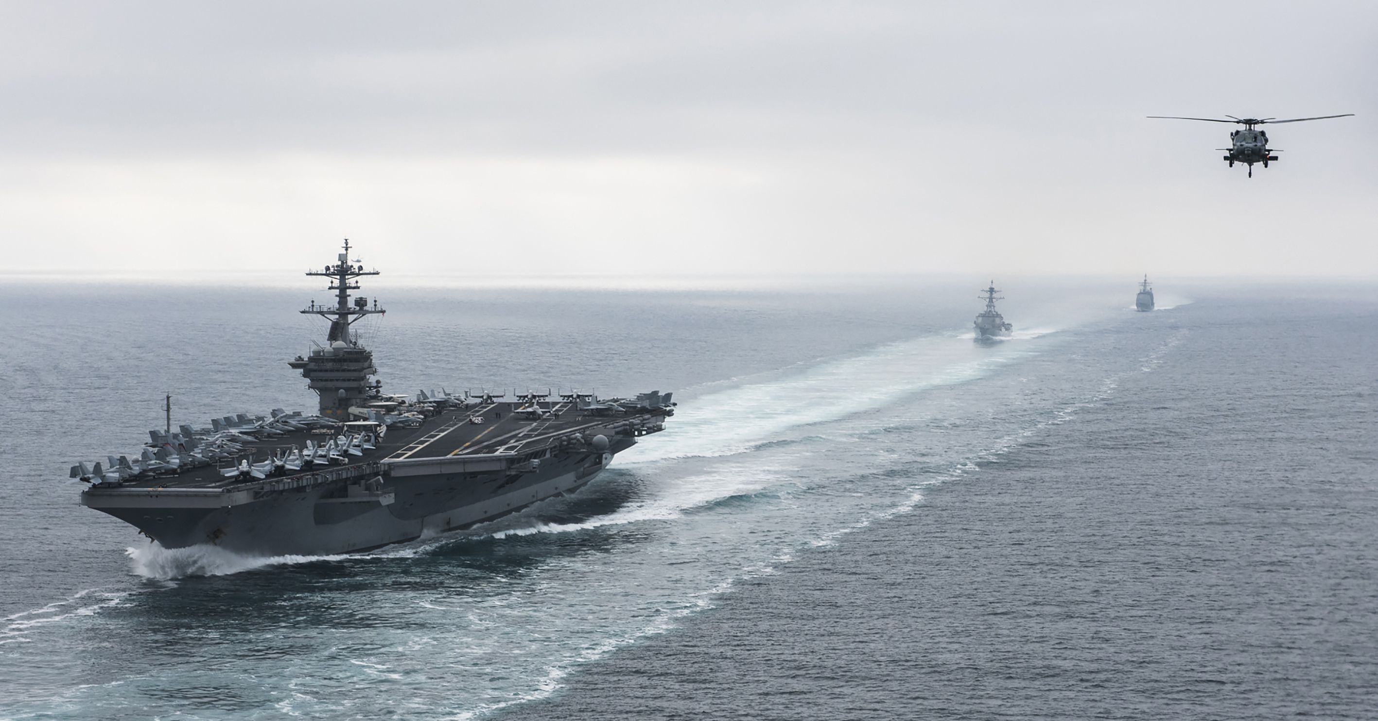 This US Navy handout photo obtained August 15, 2017 shows The aircraft carrier USS Theodore Roosevelt (CVN 71), the guided-missile destroyer USS Halsey (DDG 97), and the guided-missile cruiser USS Bunker Hill (CG 52) underway in formation during a strait transit show of force exercise on August 11, 2017 in the Pacific Ocean. (Photo/AFP)