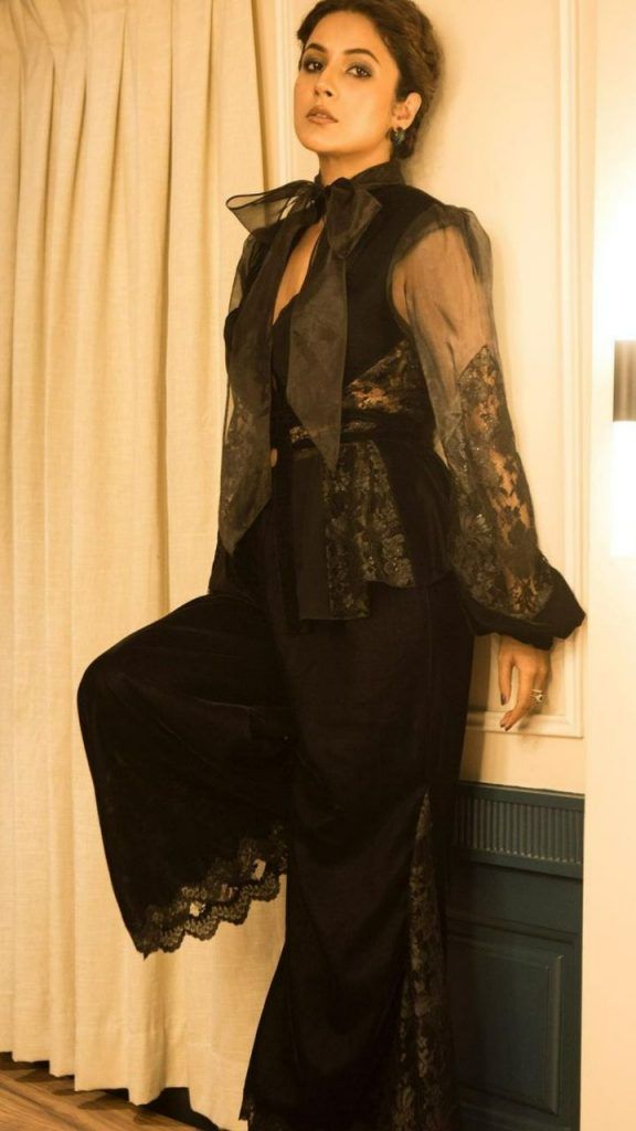 Shehnaaz Gill poses sensuously for her pictures in black shirt and lacy pants.
