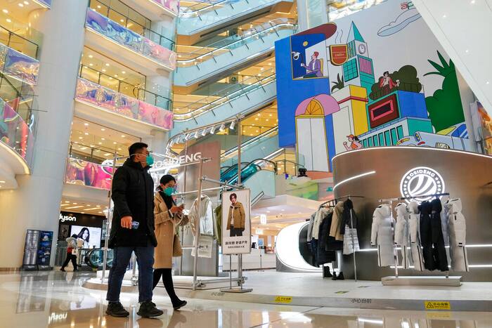 Shoppers walk through a reopened shopping mall after authorities started easing some of the anti-virus controls in Beijing (AP File Photo)