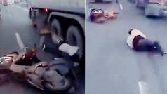 Biker Tries To Zip Through Between Two Trailers, Almost Gets Crushed: Watch