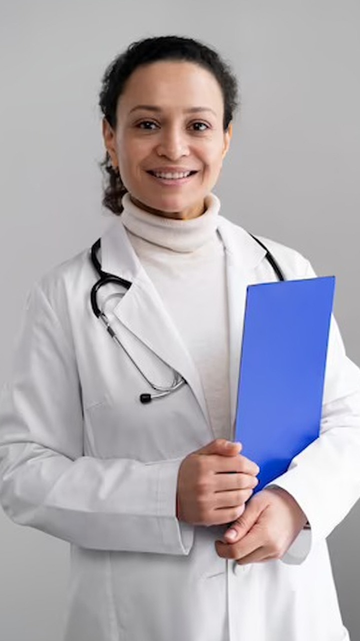 African doctor, surgeon, cardiologist or nurse in a white lab coat,  standing with folded arms holding a stethoscope in her hands Stock Photo -  Alamy