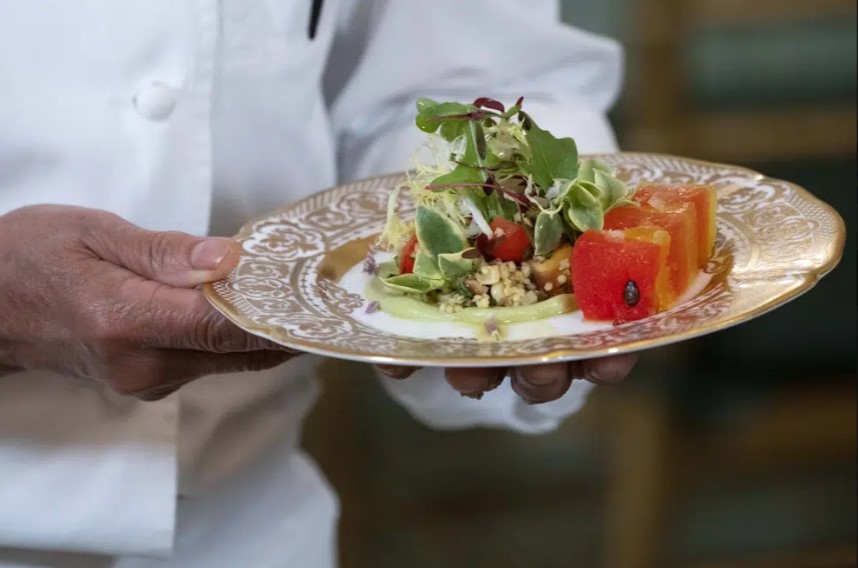 A chef prepares the first course, a salad of marinated millet and grilled corn kernels with crushed watermelon and a spicy avocado sauce, which will be served at the state dinner with India on Thursday night, during a media preview, Wednesday, June 21, 2023, at the White House in Washington.  (AP photo)