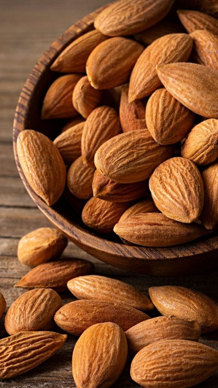 Premium Photo | Almonds on brown wooden background