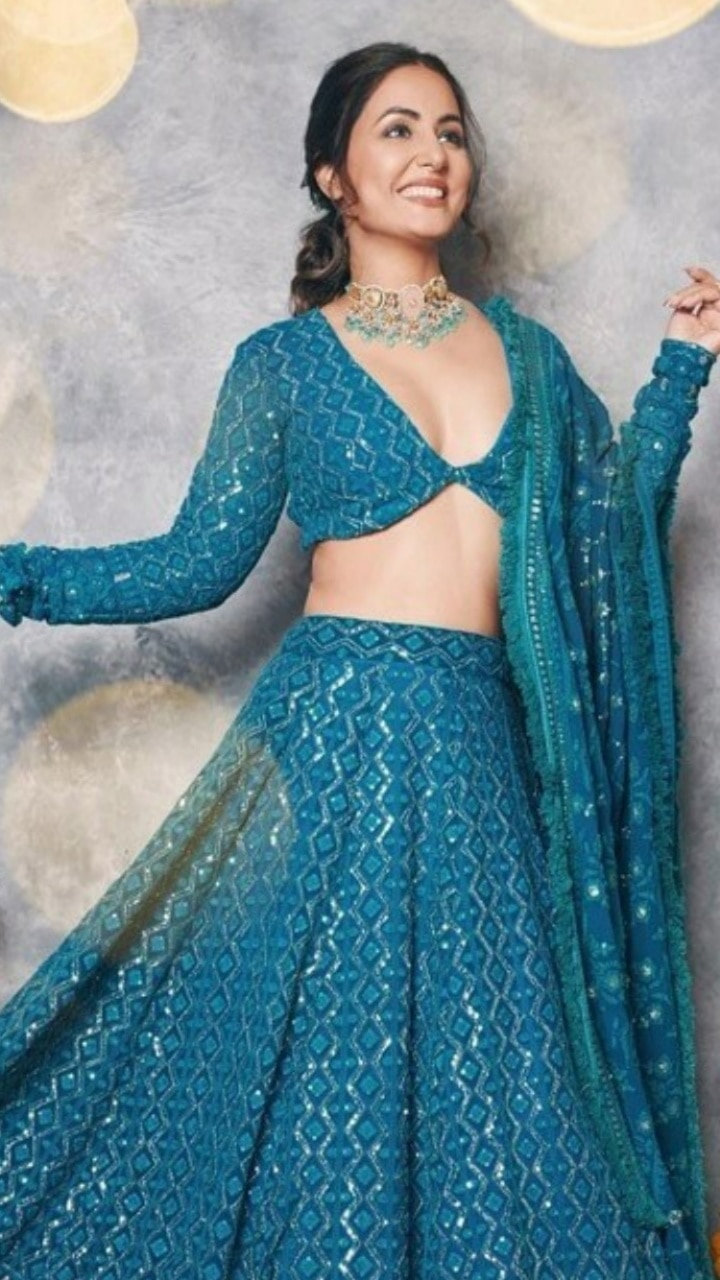 Kalanjiyam - Women party designer wear lehenga Blouse: ash color with  golden embroidery and round neck and no sleeves Lehenga: greenish blue  lehenga with navy blue and gold floral design.. with pretty