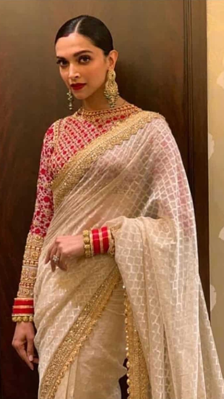 off white and golden saree with red blouse | Saree designs, Saree designs  party wear, Saree trends