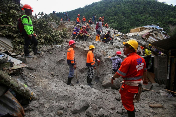 The search operation has been hampered by poor weather and fears of more landslides.