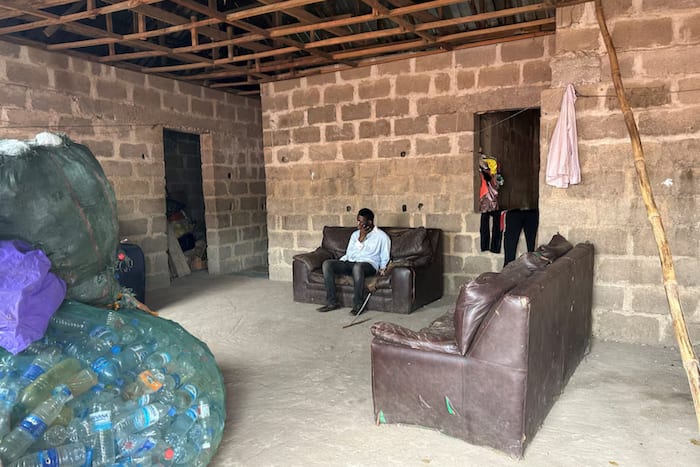 Visually-impaired Kehinde Olubotusun, using an Artificial-Intelligence-powered mobile phone for seeking information in his home in Lagos, Nigeria. Image: REUTERS/Seun Sanni