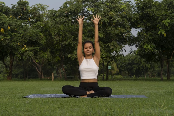 A girl is performing Bhastrika Pranayama in the park