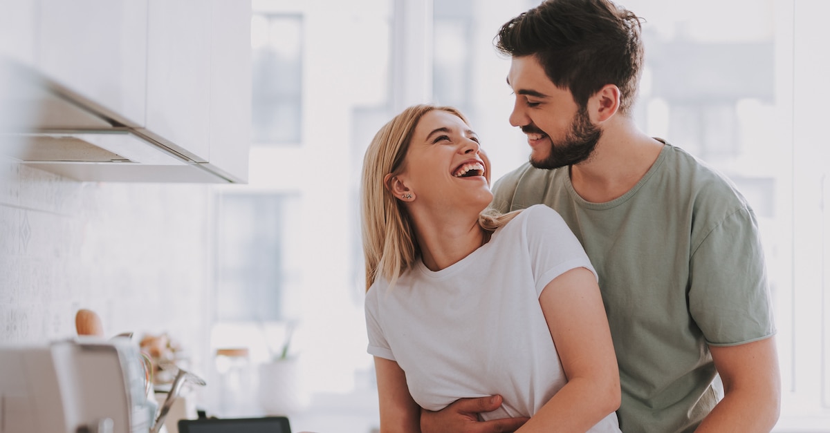 Young cheerful spouses enjoying morning time together