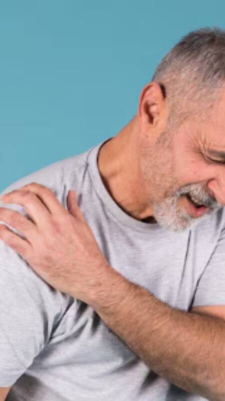 A person rubbing their sore muscles, indicating muscle pain as a Chikungunya symptom.