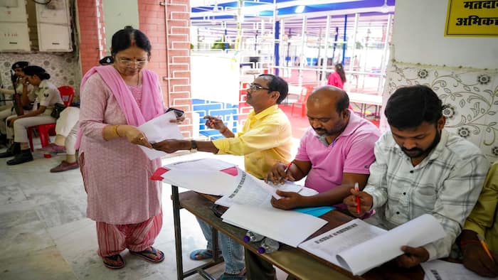 A voter arrives to cast her vote for the Graduate and Patna Teacher constituencies of the Bihar Legislative Council (MLC), in Patna